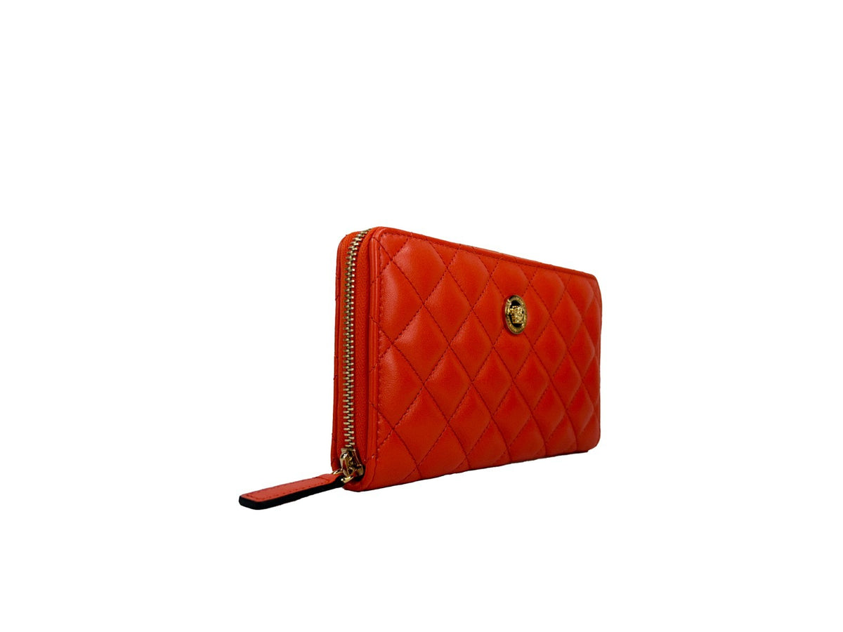 Elevate your style with the Versace Quilted Leather Continental Clutch Zip Wallet, a luxurious blend of vibrant coral and exquisite craftsmanship, perfect for any occasion.