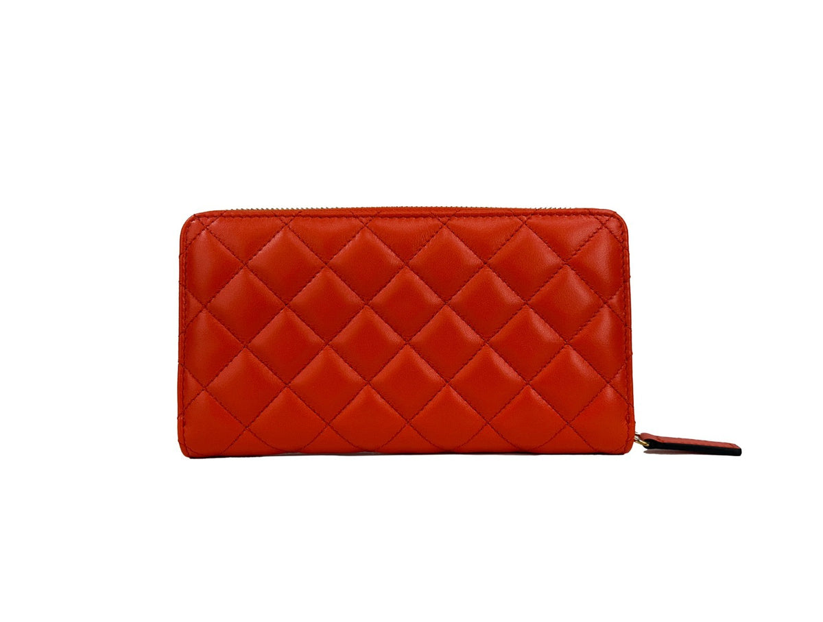 Elevate your elegance with the Versace Quilted Leather Continental Clutch Zip Wallet, a luxurious fusion of vibrant coral and exquisite craftsmanship, perfect for discerning tastes.