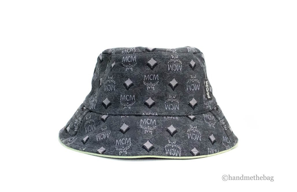 Elevate your style with the MCM Visetos Dark Grey Bucket Hat, a luxurious blend of recycled polyamide and cotton, embodying sophistication and timeless allure.