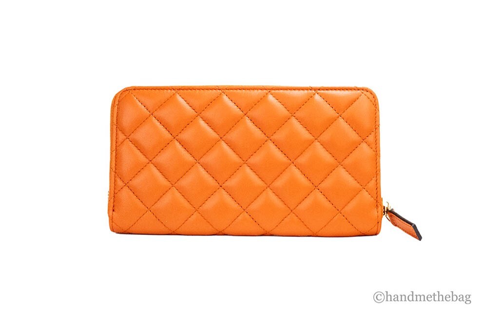 Indulge in the Versace Large Dark Orange Quilted Smooth Leather Continental Clutch, a masterpiece of exquisite craftsmanship and timeless elegance, perfect for any occasion.