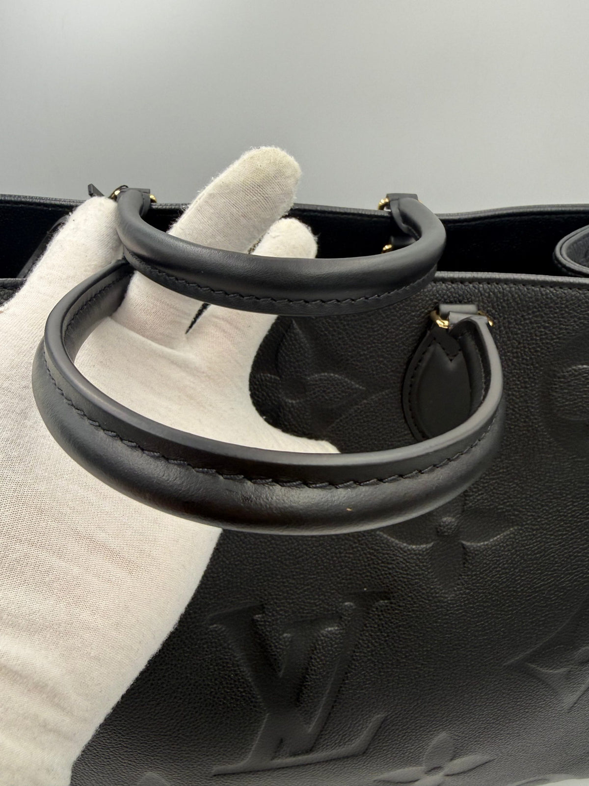 Elevate your style with the Louis Vuitton ON THE GO Empreinte GM Handbag, a timeless symbol of luxury and exquisite craftsmanship, perfect for any occasion.