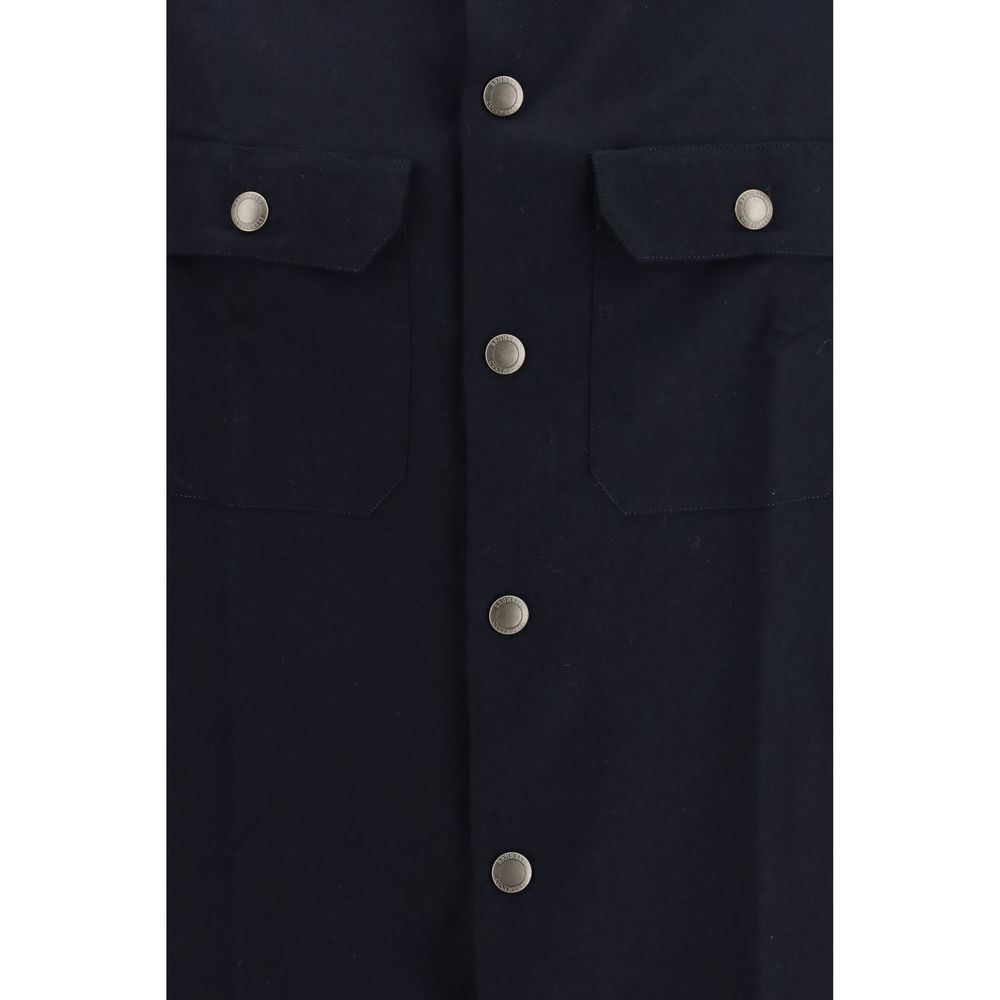 Discover the Brunello Cucinelli Blue Wool Oves Aries Shirt, a masterpiece of 100% fleece wool, merging timeless elegance with unparalleled craftsmanship for the discerning individual.