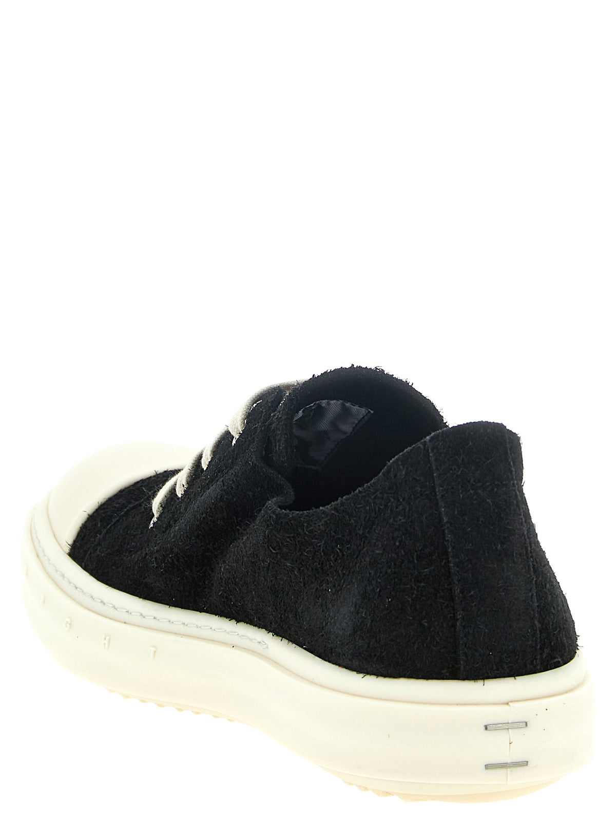 Step into a realm of sophistication with Rick Owens' Black Calfskin Low Top Sneakers, where architectural elegance meets luxurious craftsmanship, redefining street-style allure.