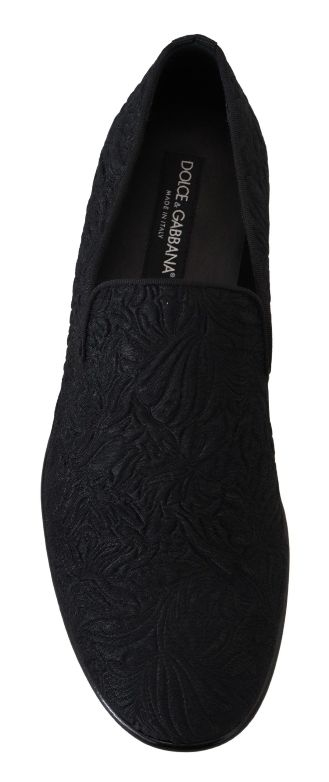 Indulge in the exquisite Dolce & Gabbana Black Floral Jacquard Slippers, handcrafted in Italy from a luxurious blend of materials, embodying timeless elegance and sophistication.