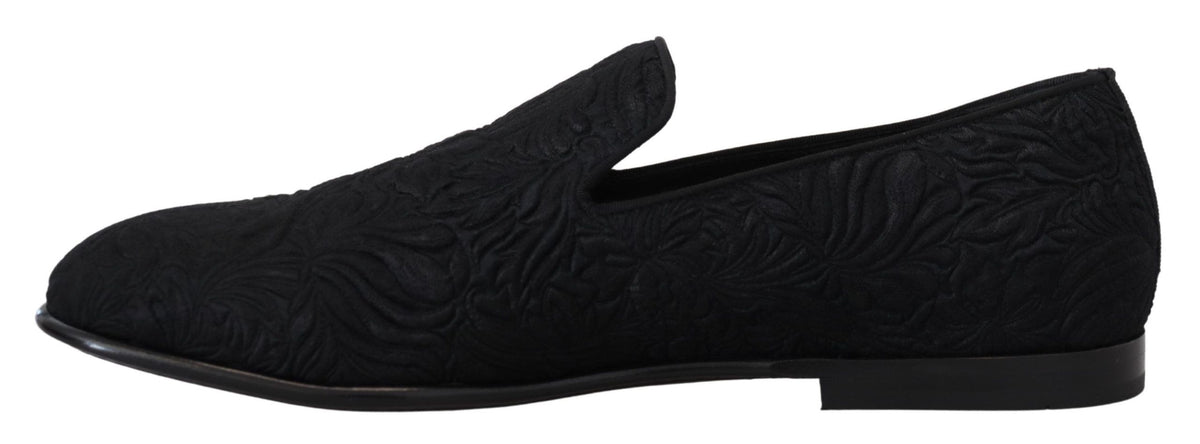 Indulge in the exquisite Dolce & Gabbana Black Floral Jacquard Slippers, handcrafted in Italy from a luxurious blend of materials, embodying timeless elegance and sophistication.