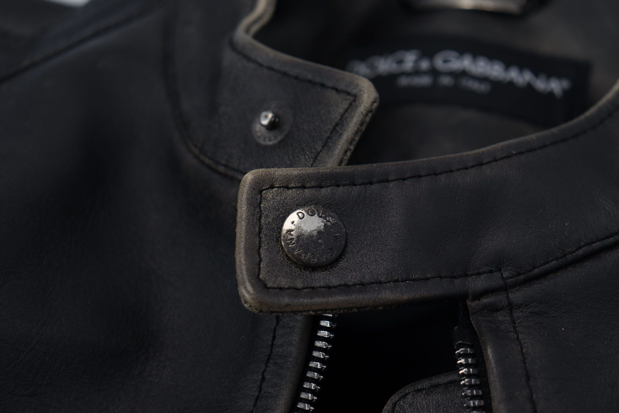 Indulge in the exquisite Dolce & Gabbana Black Leather Zipper Biker Coat Jacket, a luxurious statement of Italian craftsmanship and timeless elegance, perfect for the discerning individual.