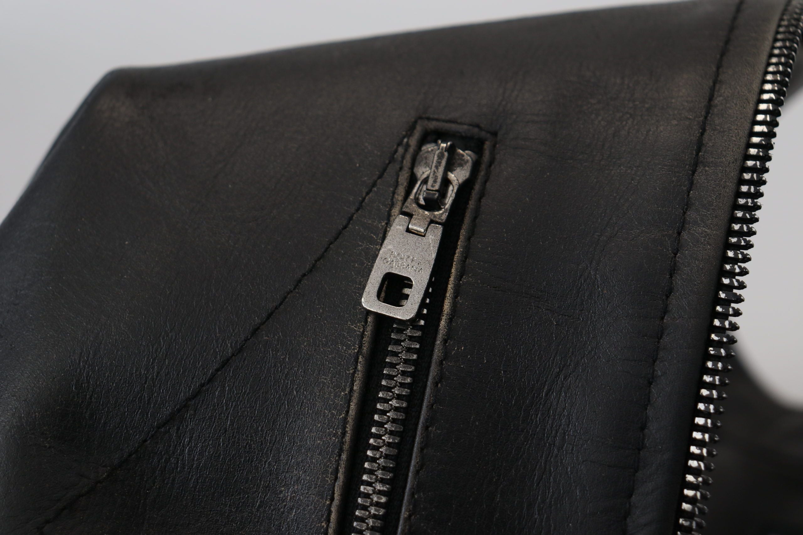 Indulge in the exquisite Dolce & Gabbana Black Leather Zipper Biker Coat Jacket, a masterpiece of Italian craftsmanship that embodies luxury and sophistication for the discerning individual.