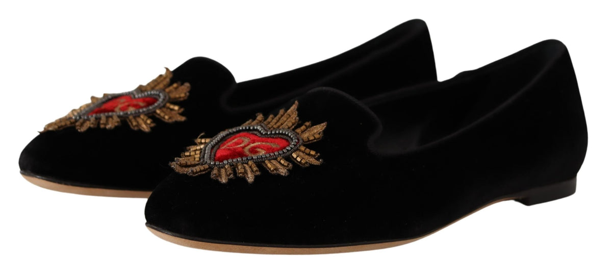 Experience the exquisite allure of Dolce & Gabbana's Black DG Sacred Heart Patch Slip On Flats, crafted from luxurious leather for timeless elegance and effortless sophistication.