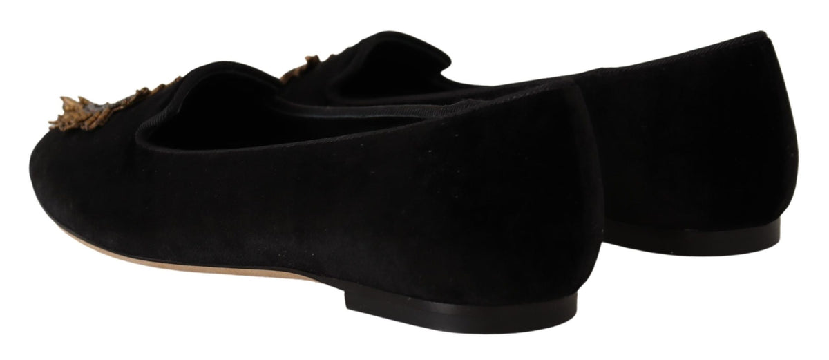 Indulge in the exquisite craftsmanship of Dolce & Gabbana's Black DG Sacred Heart Patch Slip On Flats, where luxurious leather meets iconic elegance for a statement of refined sophistication.