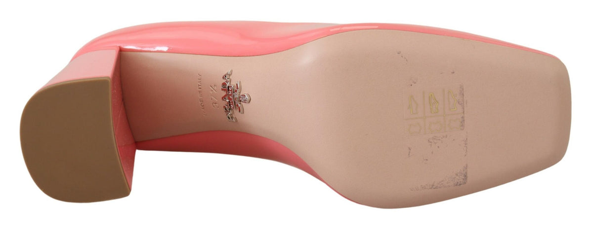Experience the exquisite allure of Prada Pink Patent Leather Block Heels, a timeless masterpiece crafted in Italy, embodying luxury and sophistication for the discerning individual.