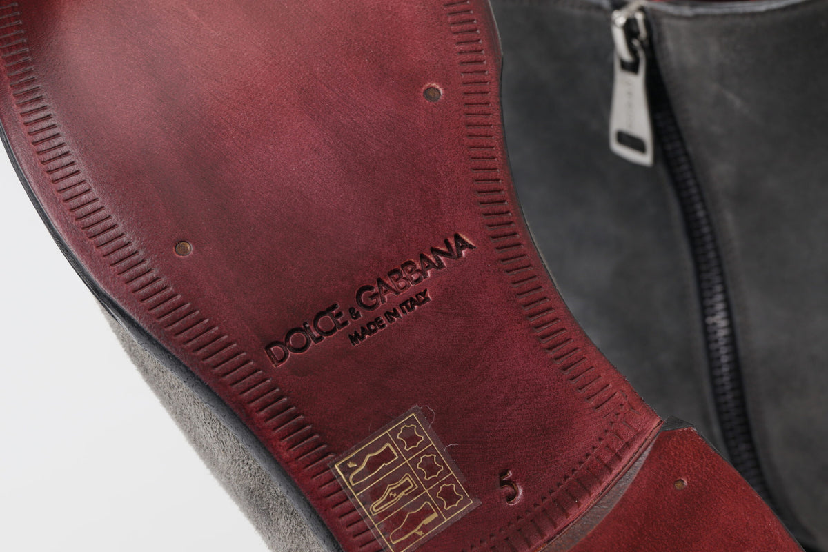 Step into sophistication with Dolce & Gabbana Gray Leather Ankle Boots, handcrafted in Italy from 100% genuine leather, embodying timeless elegance and luxury.