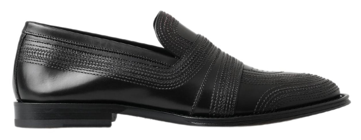 Experience the exquisite craftsmanship of Dolce & Gabbana Black Leather Slipper Loafers, where timeless elegance meets luxurious comfort for the discerning individual.