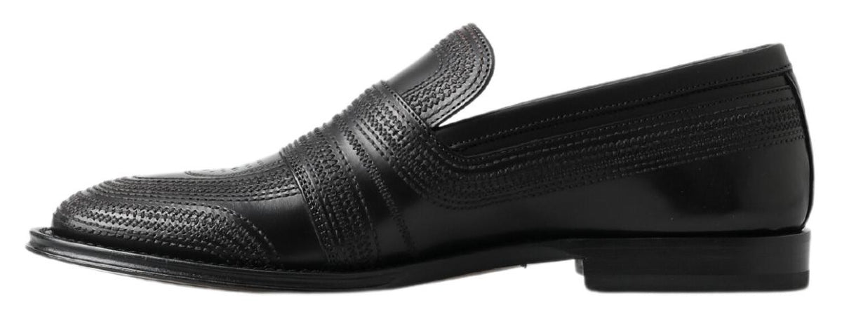 Step into a world of refined elegance with Dolce & Gabbana Black Leather Slipper Loafers, where artisanal craftsmanship meets luxurious comfort for the discerning individual.