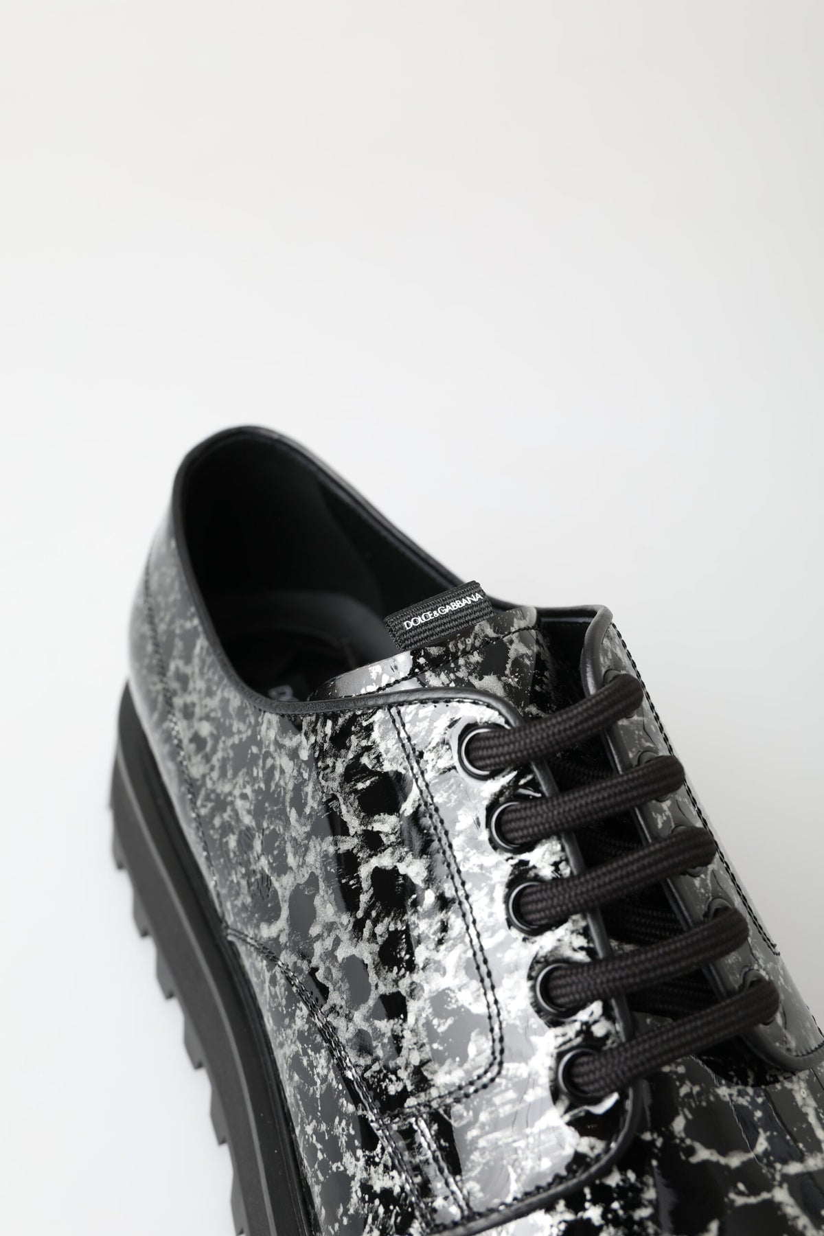 Step into sophistication with Dolce & Gabbana's Black White Derby Patent Leather Shoes, where exquisite craftsmanship meets luxurious materials for timeless elegance.