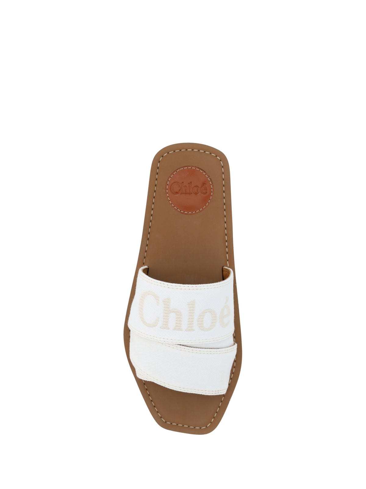 Experience the allure of Chloé White Cotton Slides Woody Sandals, where luxurious cotton and rubber craftsmanship meets timeless elegance, perfect for the discerning individual.