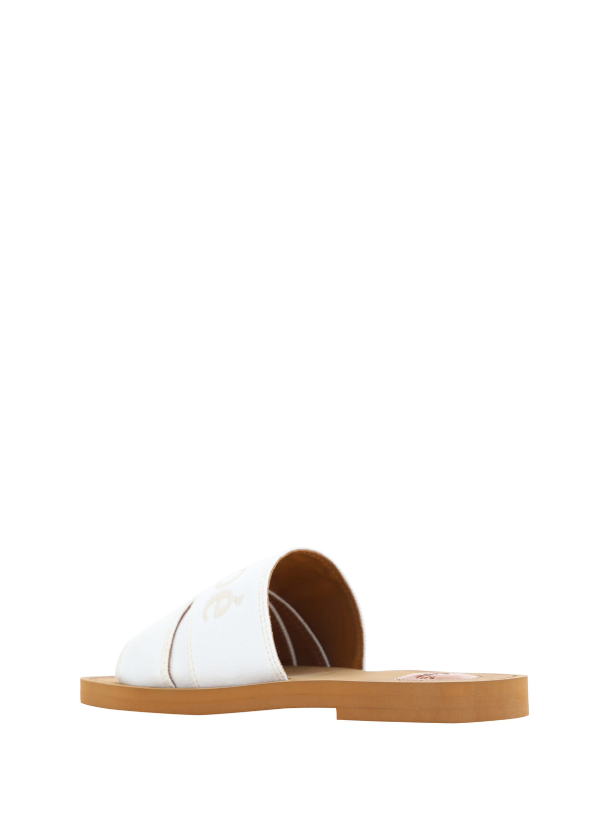 Experience the exquisite Chloé White Cotton Slides Woody Sandals, crafted from 100% cotton and rubber, embodying luxury and timeless elegance for the discerning individual.