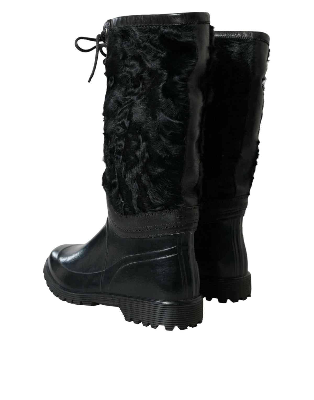 Indulge in the exquisite Dolce & Gabbana Black Rubber Lace Up Shearling Rain Boots, where plush shearling meets durable elegance, embodying timeless luxury for the discerning individual.