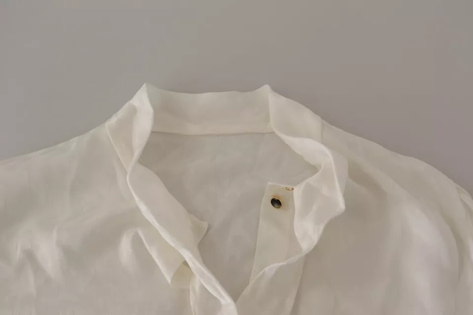 Indulge in the exquisite allure of the Dolce & Gabbana White Patterned Silk Ascot Collar Blouse, a timeless piece crafted from luxurious silk, embodying elegance and sophistication.