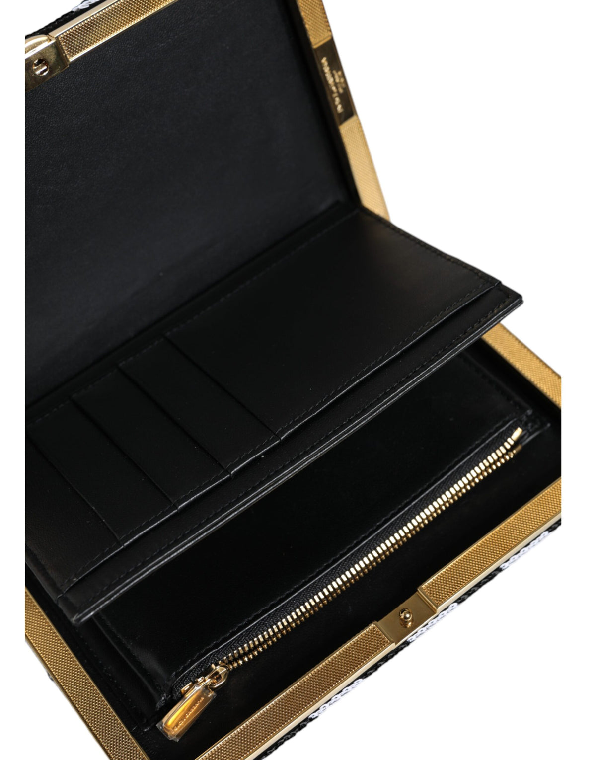 Discover the Dolce & Gabbana Black White Gold Frame Clutch, an exquisite blend of luxury materials and Italian craftsmanship, perfect for the discerning individual.