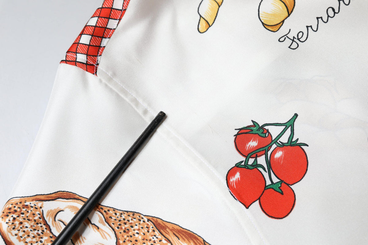 Indulge in the exquisite allure of the Dolce & Gabbana Multicolor Bread Print Collared Blouse, a silk masterpiece that embodies sophistication and timeless elegance.