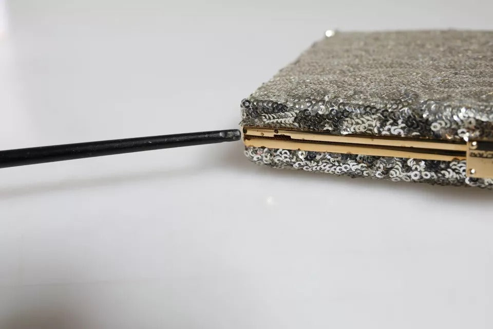 Indulge in the exquisite allure of the Dolce & Gabbana Silver Sequined Clutch, a timeless masterpiece that elevates evening elegance with luxurious craftsmanship and opulent detailing.