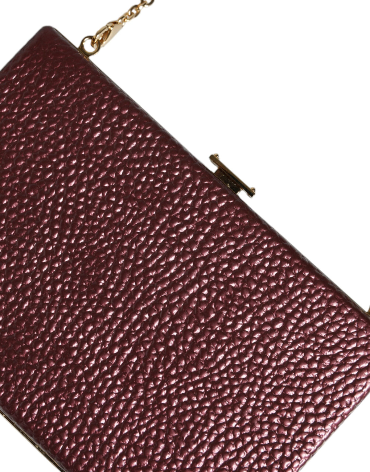 Elevate your elegance with the Dolce & Gabbana Maroon Leather Clutch, a masterpiece of Italian craftsmanship designed for the discerning individual.