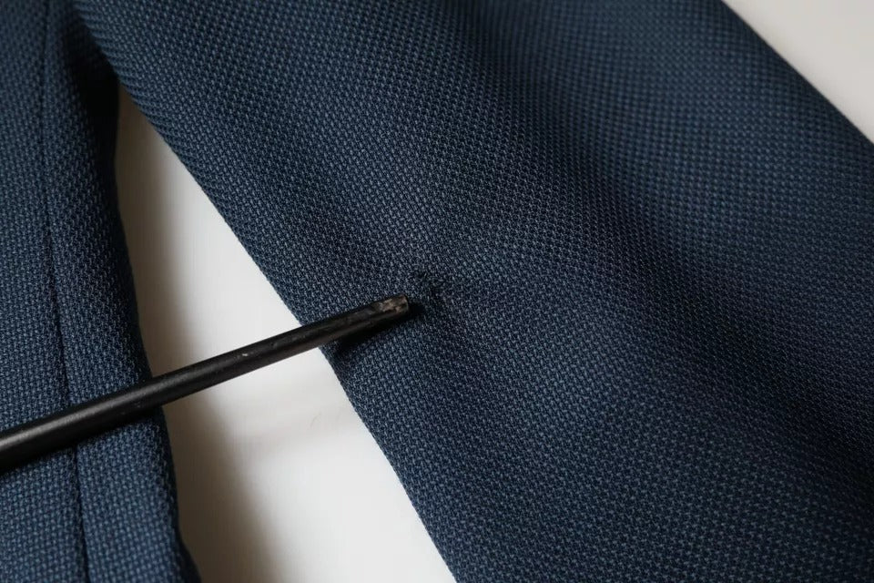 Indulge in the exquisite Dolce & Gabbana Blue Wool Logo Blazer, a masterpiece of Italian craftsmanship that embodies timeless elegance and luxurious allure.
