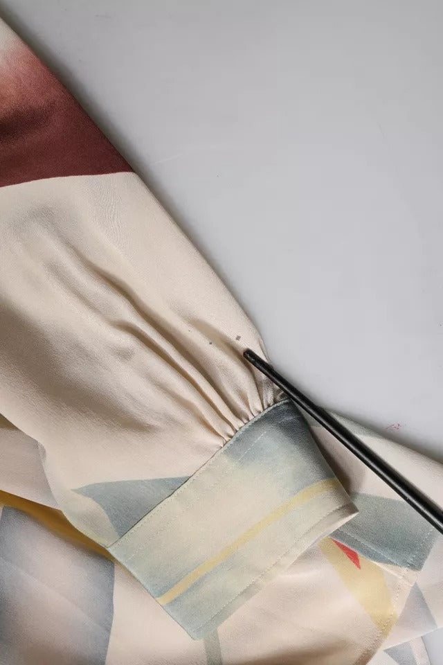 Elevate your wardrobe with the Etro Beige Printed Silk Blouse, a timeless masterpiece crafted in Italy, embodying luxury and sophistication for the discerning individual.