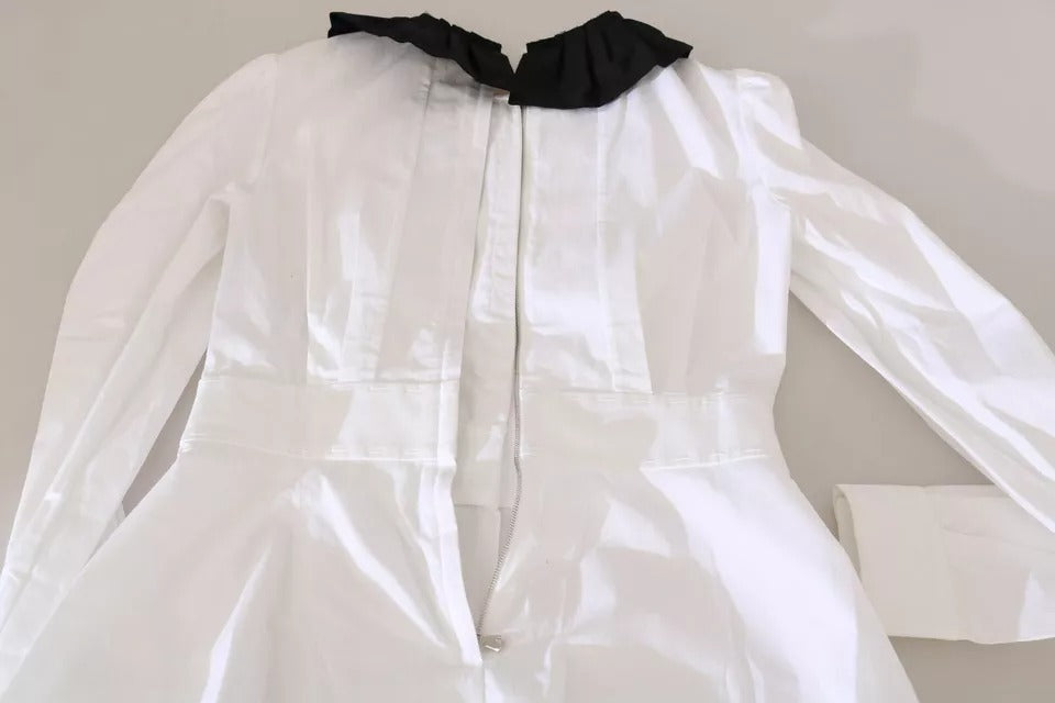Elevate your wardrobe with the Dolce & Gabbana Black White Decorative Buttons Blouse, a masterpiece of Italian craftsmanship in luxurious cotton blend, embodying timeless elegance and sophistication.