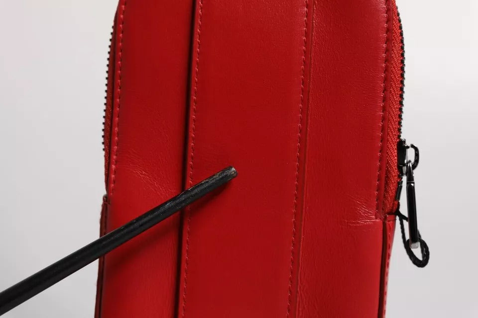 Experience the allure of Dolce & Gabbana's Red Leather Logo Zip Around Card Holder, a masterpiece of Italian craftsmanship that embodies timeless elegance and sophisticated luxury.