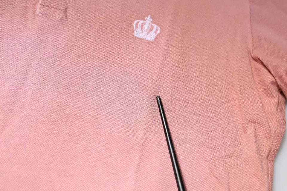 Experience the allure of Dolce & Gabbana's Pink Crown Collared Polo, crafted from luxurious Italian cotton, embodying sophistication and timeless elegance for the discerning individual.