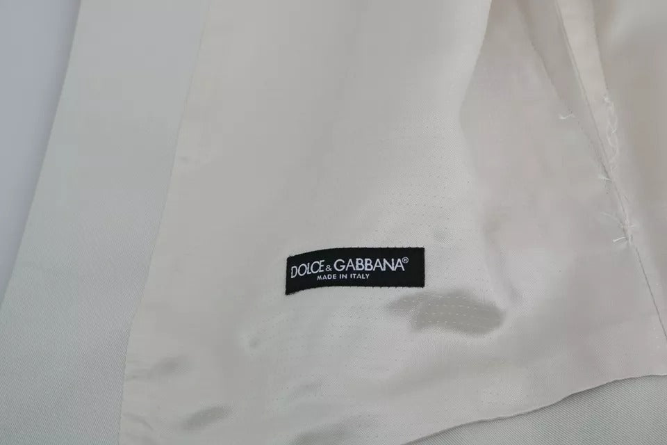Indulge in the exquisite Dolce & Gabbana Off-White Cotton Silk Formal Coat Vest, a timeless statement of Italian craftsmanship and refined elegance for the discerning individual.