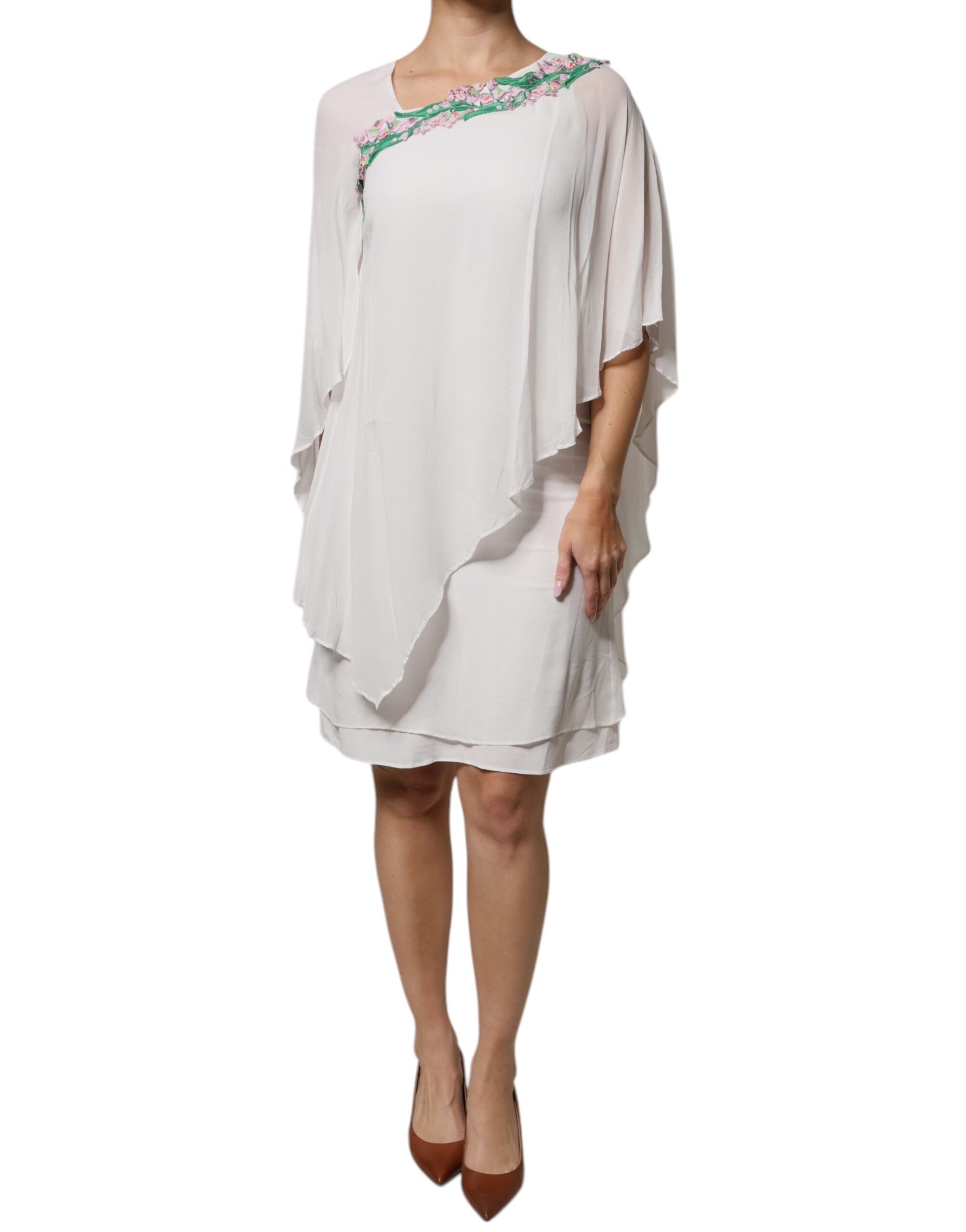 Indulge in the exquisite Blumarine White Floral Embroidery Viscose Chiffon Shift Dress, a masterpiece of Italian craftsmanship that embodies timeless elegance and sensual allure.