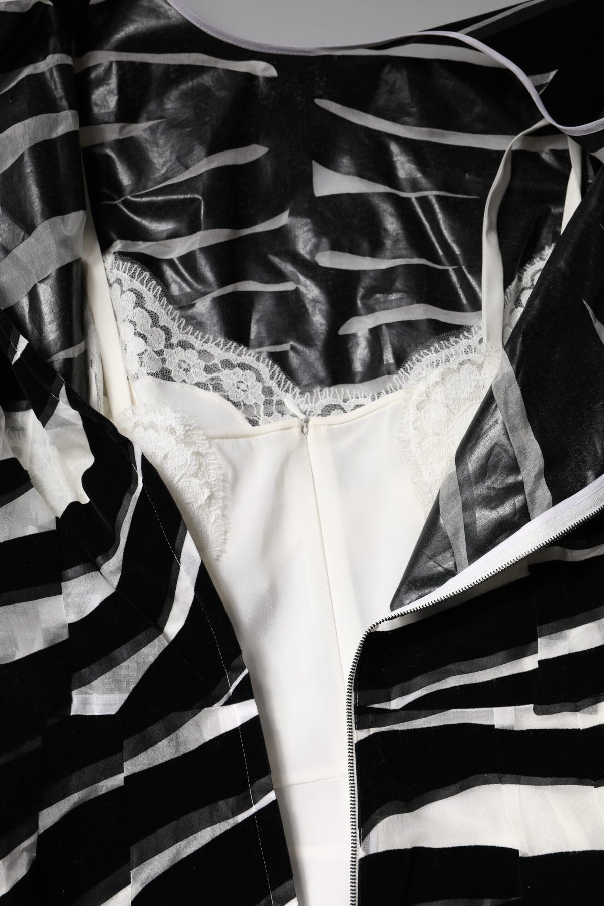 Elevate your wardrobe with the Dolce & Gabbana Black White Zebra A-line Sheath Mini Dress, a luxurious blend of silk and nylon that embodies haute couture elegance and timeless sophistication.
