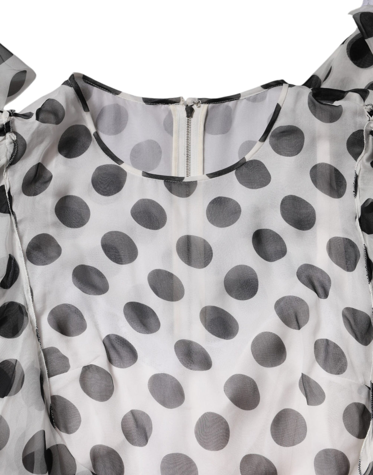 Indulge in the exquisite Dolce & Gabbana White Polka Dotted Silk Blend A-line Dress, a timeless piece that embodies luxury, sophistication, and effortless elegance for any occasion.