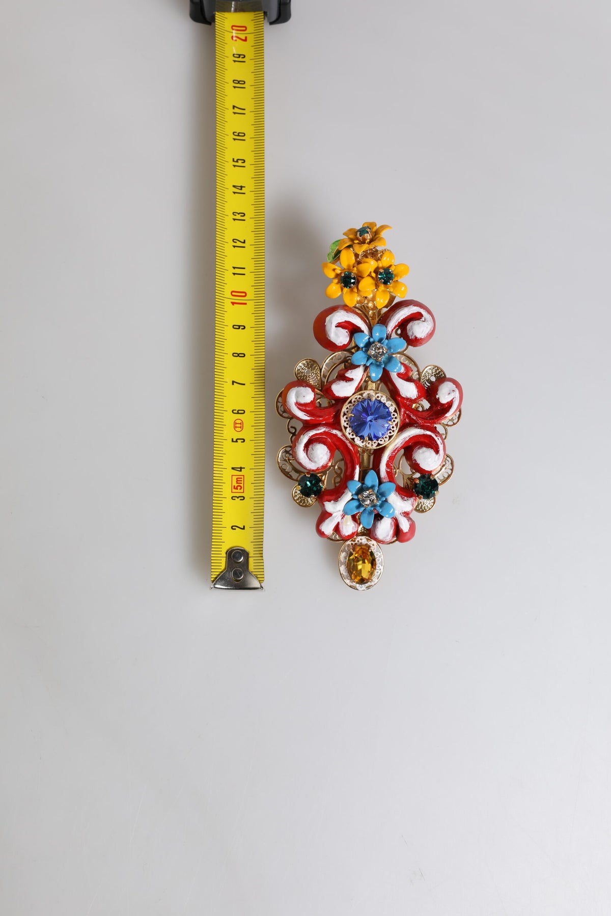 Indulge in the exquisite allure of the Dolce & Gabbana Multicolor Spring CARRETTO Hair Clip, a luxurious blend of brass and crystal, embodying timeless elegance and artistry.