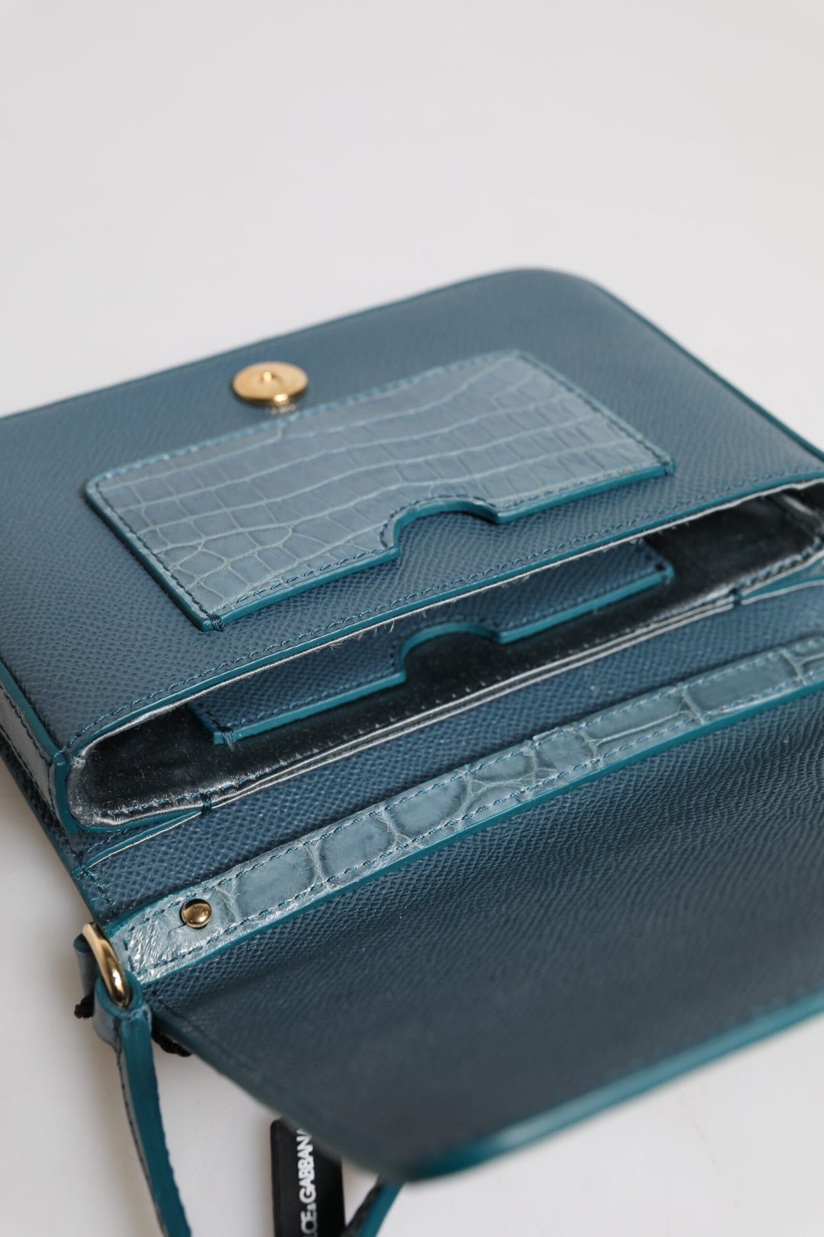 Discover the Dolce & Gabbana Green Exotic Leather DG Plaque Crossbody Mini Bag, a luxurious blend of crocodile and calf leather, embodying elegance and sophistication for the discerning individual.