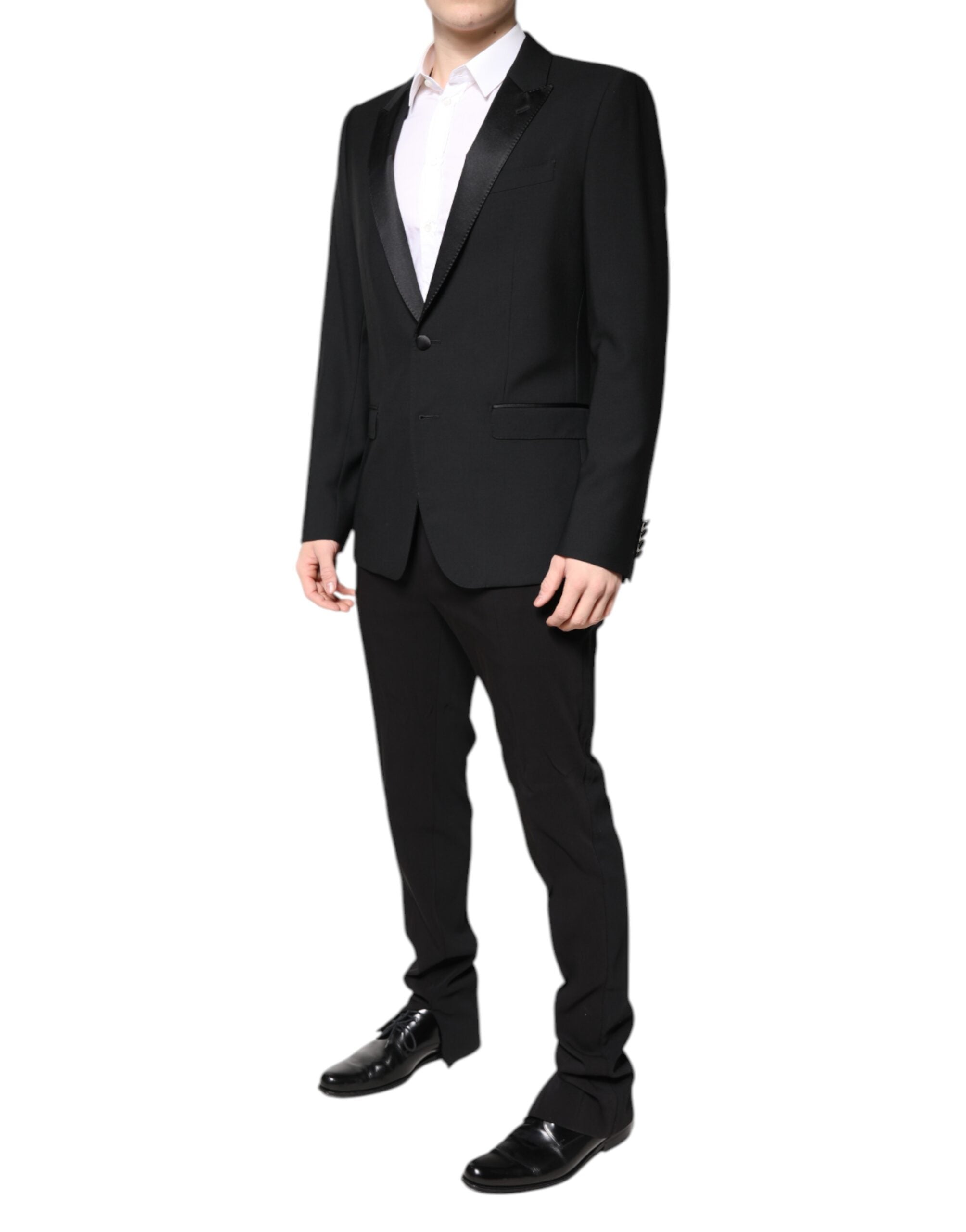 Experience opulent elegance with the Dolce & Gabbana Black Wool Single Breasted 2 Piece Suit, crafted from a luxurious blend of virgin wool and silk for timeless sophistication.