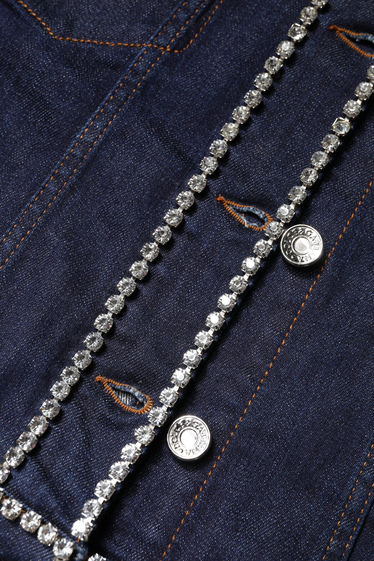 Elevate your wardrobe with the Dolce & Gabbana Blue Denim Cotton Crystal Embellished Jacket, a masterpiece of Italian craftsmanship that embodies timeless luxury and sophisticated allure.
