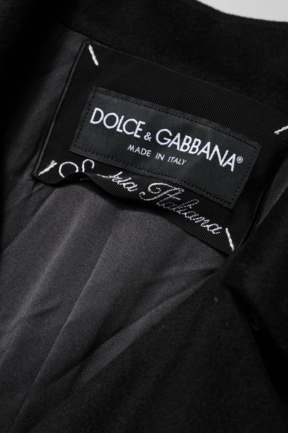 Indulge in the exquisite craftsmanship of the Dolce & Gabbana Black Wool Sartoria Italiano Blazer, a timeless piece that embodies luxury and sophistication for the discerning individual.