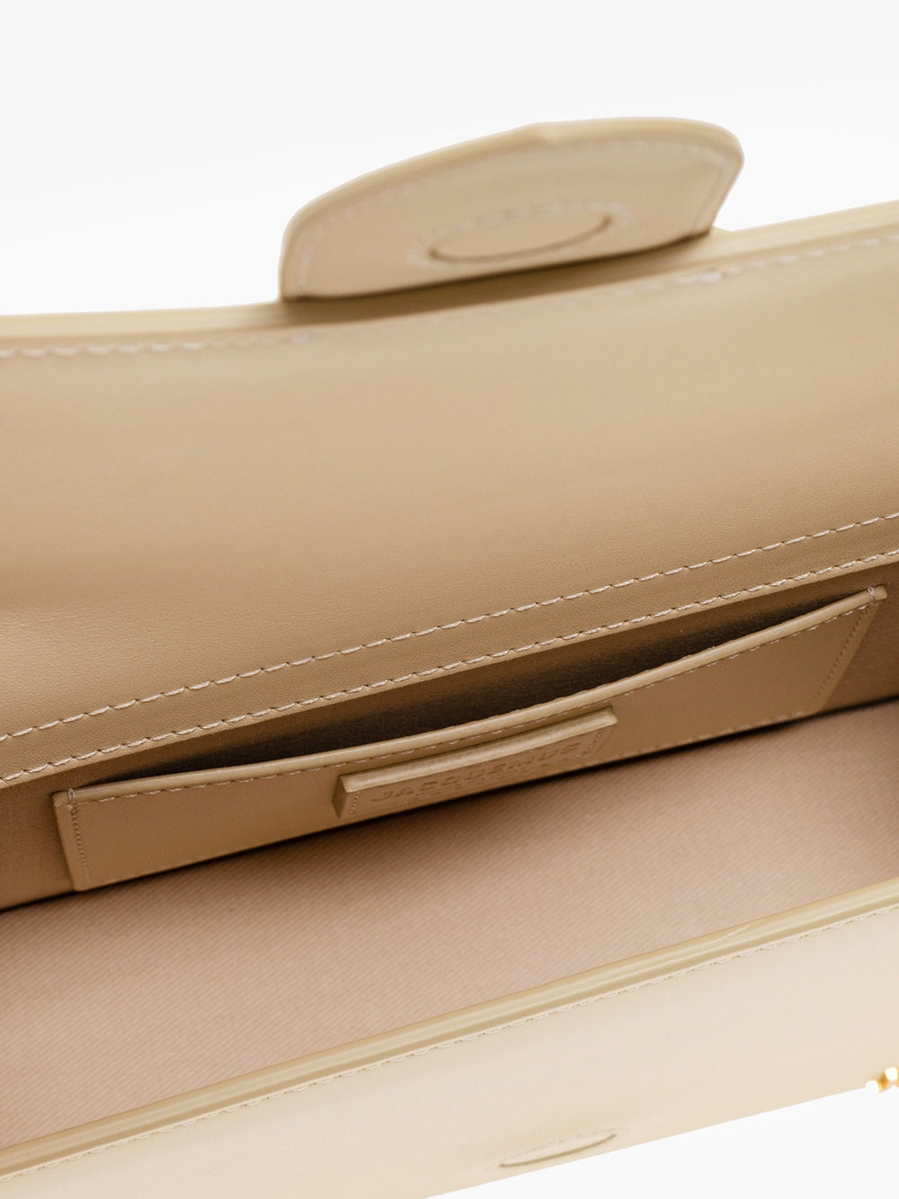 Indulge in the elegance of the Jacquemus Le Grand Bambino Beige Bag, a masterpiece of leather craftsmanship that embodies timeless sophistication and allure.