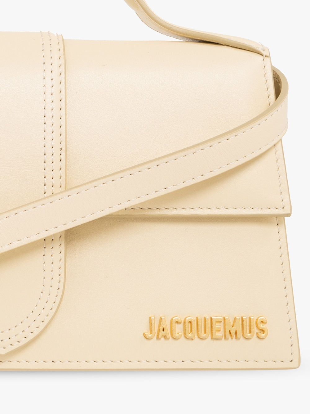 Indulge in the elegance of the Jacquemus Le Grand Bambino Beige Bag, a masterpiece of leather craftsmanship that embodies luxury and sophistication for the discerning individual.