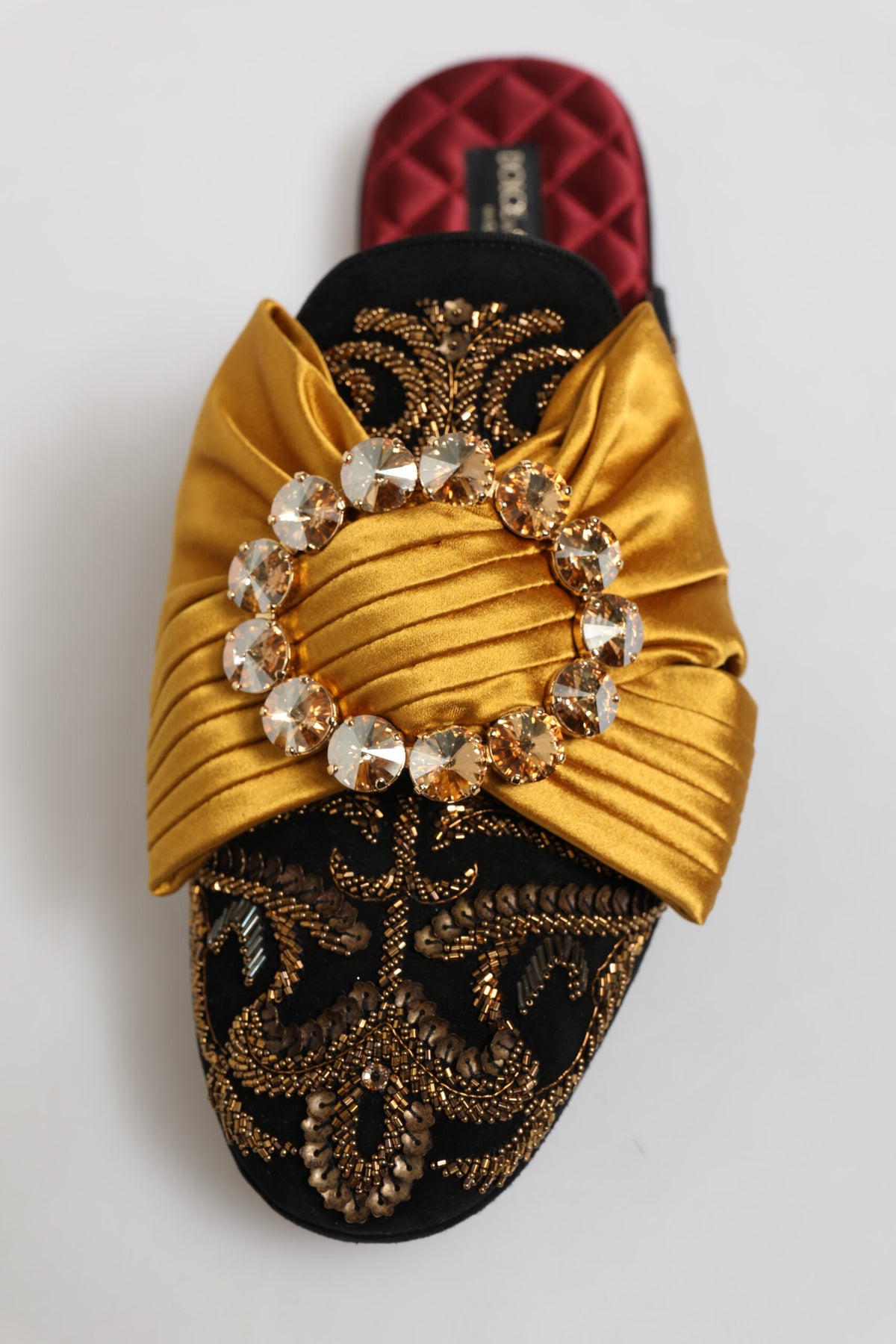 Indulge in the exquisite craftsmanship of Dolce & Gabbana's multicolor embellished flat sandals, where luxurious materials meet timeless elegance for a captivating statement.