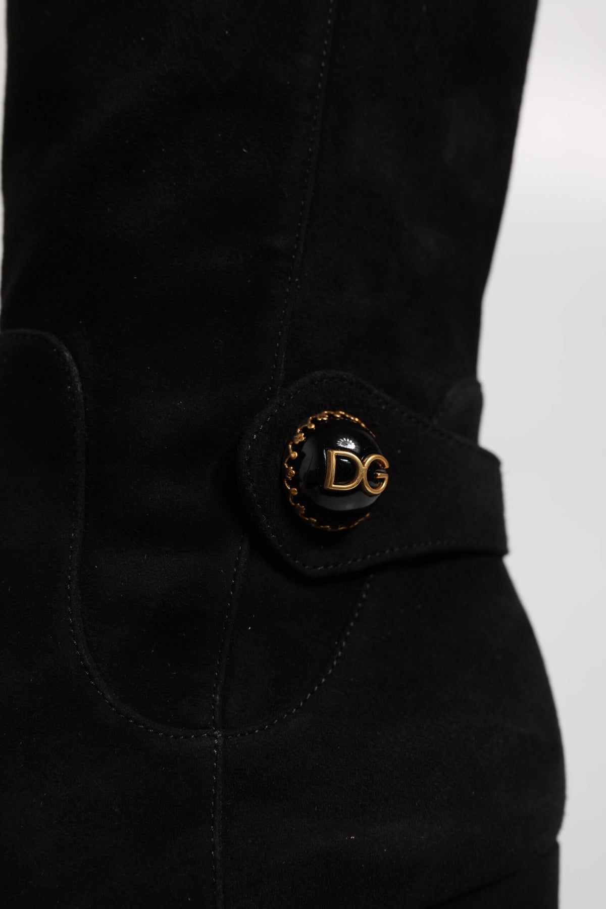 Indulge in the exquisite craftsmanship of Dolce & Gabbana's Black Suede Leather Knee High Boots, a timeless symbol of luxury that elevates your style with every step.