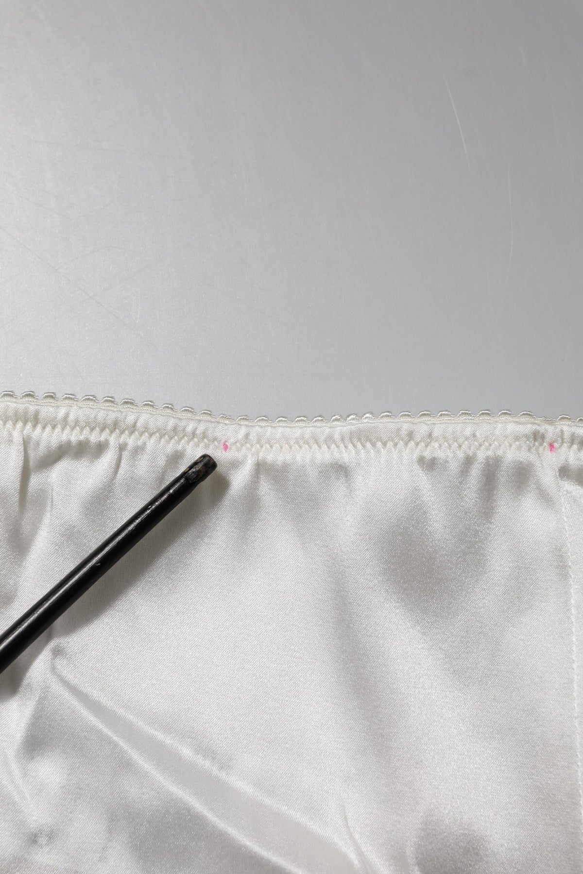 Indulge in the exquisite Dolce & Gabbana Ivory Silk Tapered High Waist Pants, a testament to Italian artistry that elevates your elegance and allure for any occasion.