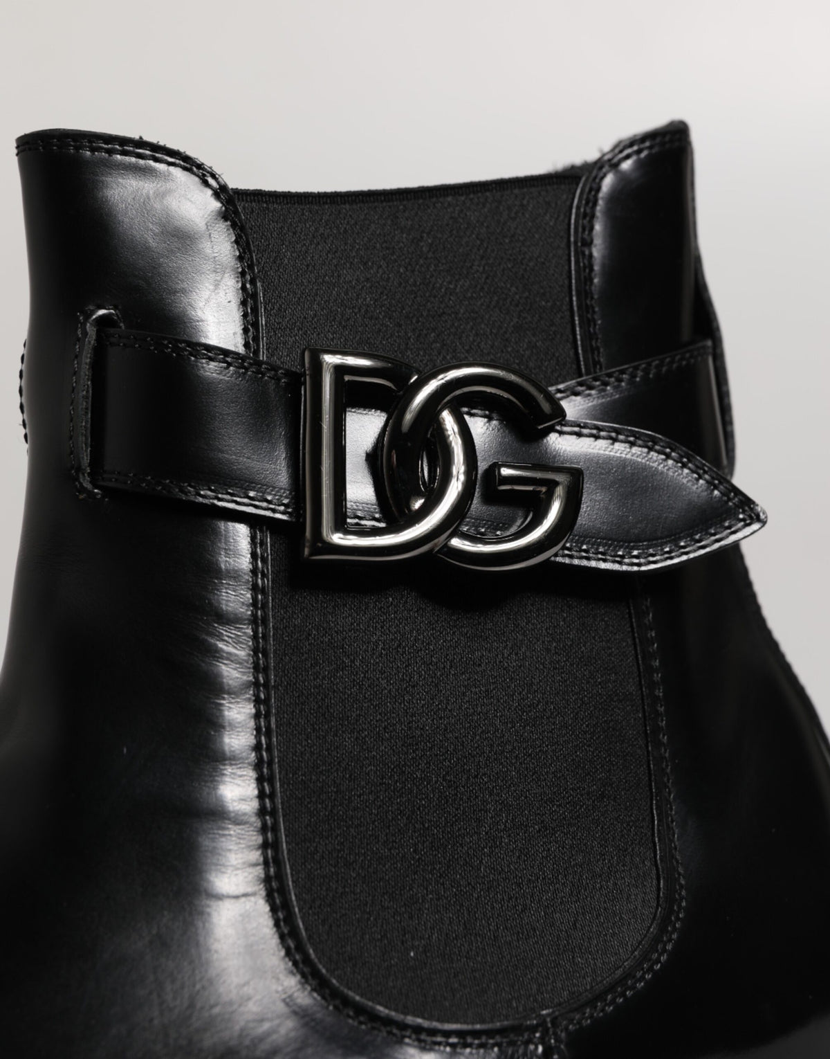 Step into unparalleled elegance with Dolce & Gabbana's Black Belted DG Logo Chelsea Boots, crafted from premium calf leather for a luxurious statement in every stride.