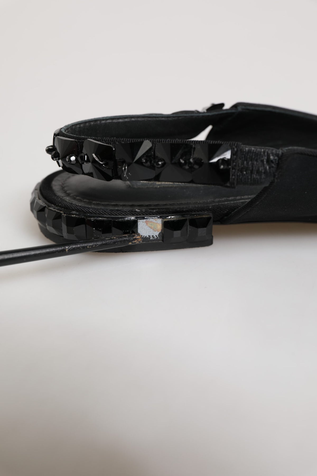 Indulge in the allure of Dolce & Gabbana's Black Crystal Charmeuse Slingback Shoes, crafted from luxurious silk for a sophisticated touch that elevates any ensemble.
