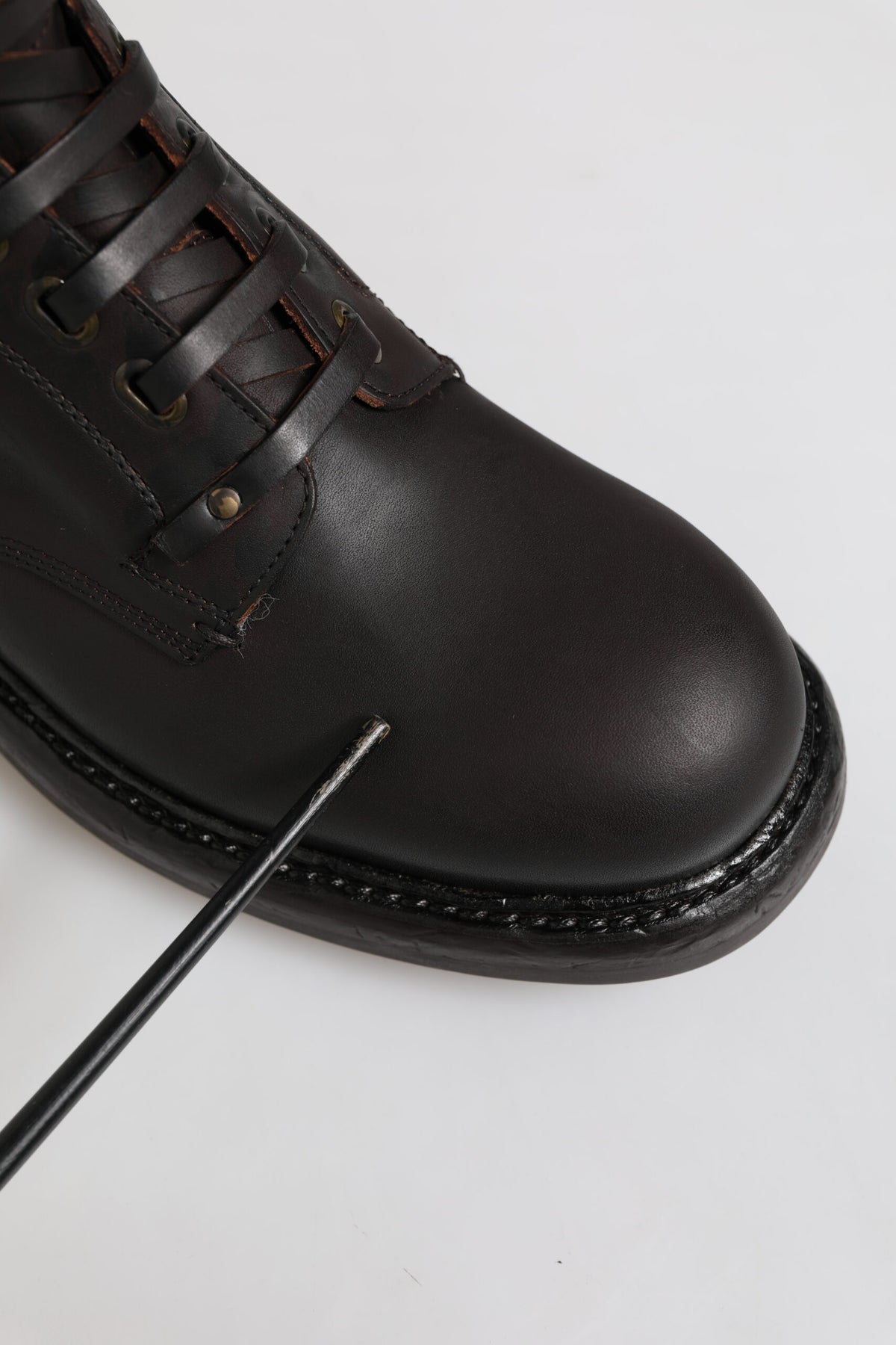 Indulge in the exquisite allure of Dolce & Gabbana's Dark Brown Leather Lace Up Mid Calf Boots, where Italian craftsmanship meets timeless elegance for the discerning individual.