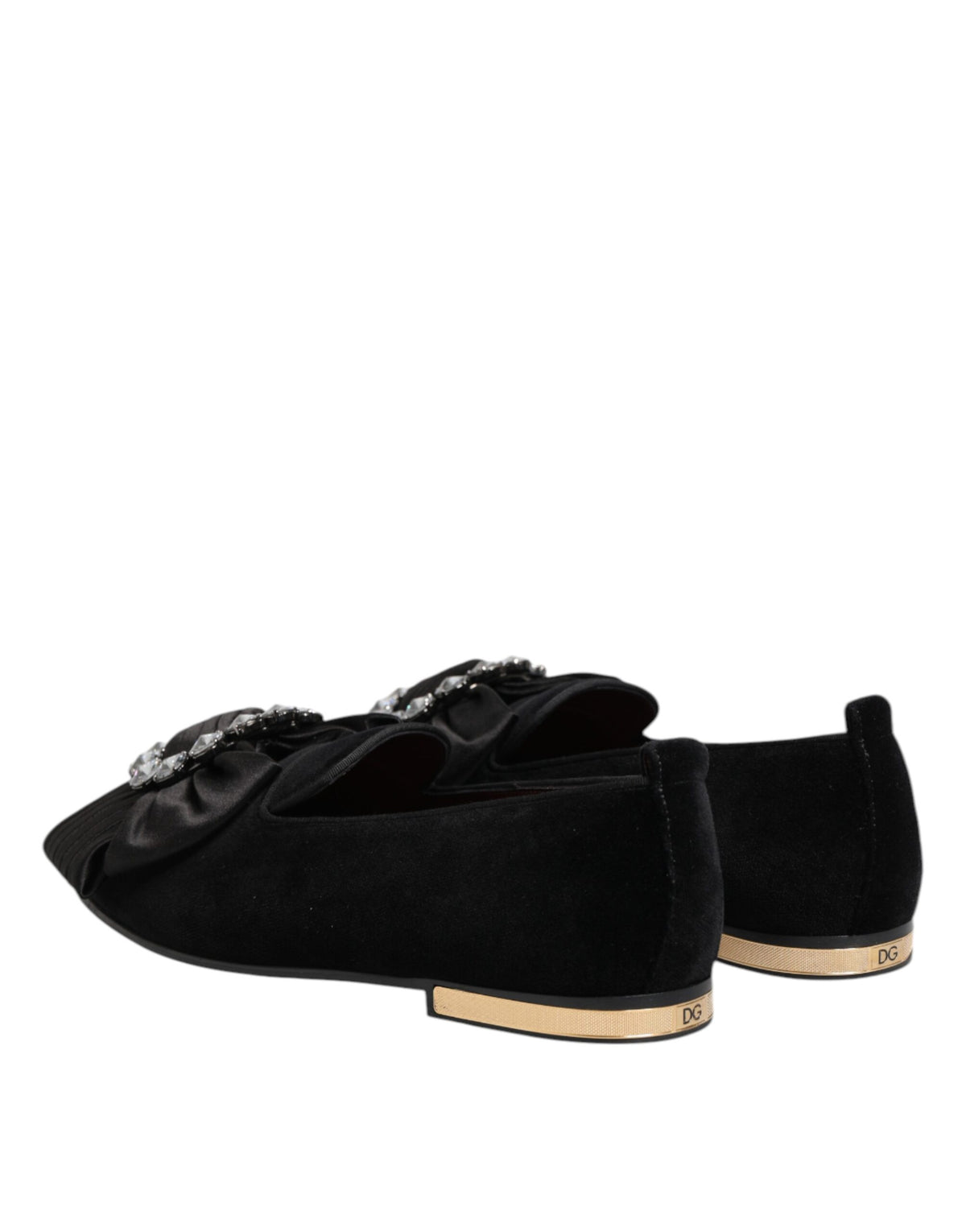 Step into refined elegance with Dolce & Gabbana's Black VATICANO Crystal Ribbon Slip On Shoes, crafted from luxurious materials to elevate your sophisticated style.