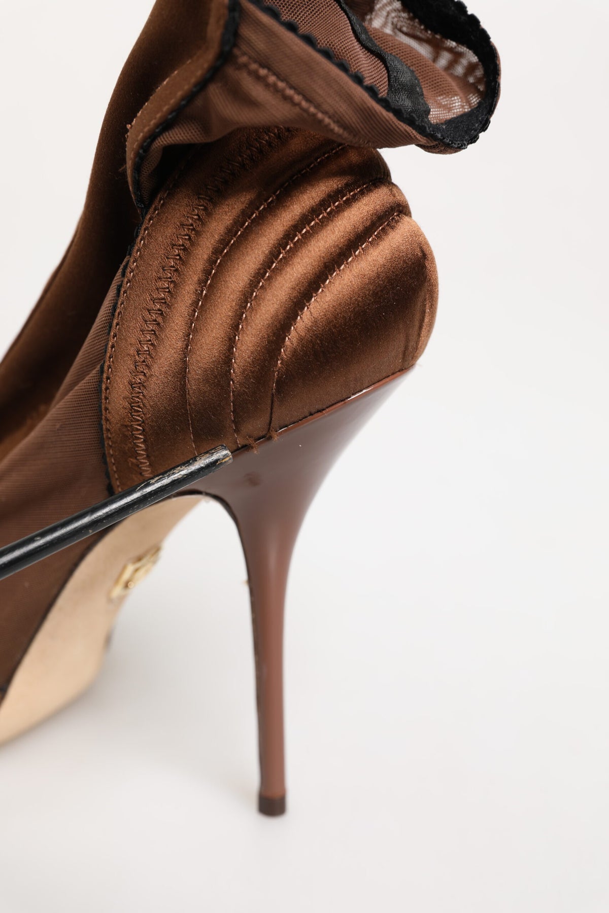 Indulge in the exquisite craftsmanship of Dolce & Gabbana's Brown Bette High Heeled Ankle Boots, where luxurious silk and calfskin elevate your style to new heights.